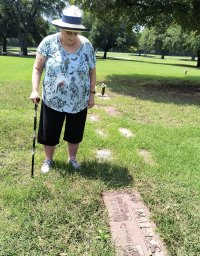 Cousin Beverly examining grave of grandfather Charlie Miles